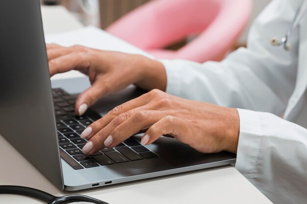 Doctor working on a laptop close-up