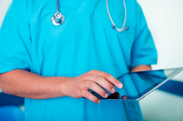 Doctor working using digital tablet
