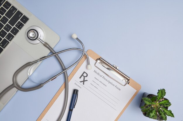 Doctor workplace. Top view of doctor office work with stethoscope, laptop, pen, and clipboard with copy space for your text. Modern medical Information technology. flat lay, copy space.