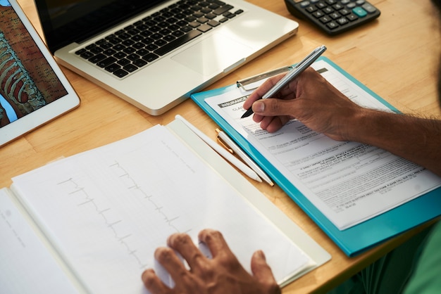 Doctor writing medical notes