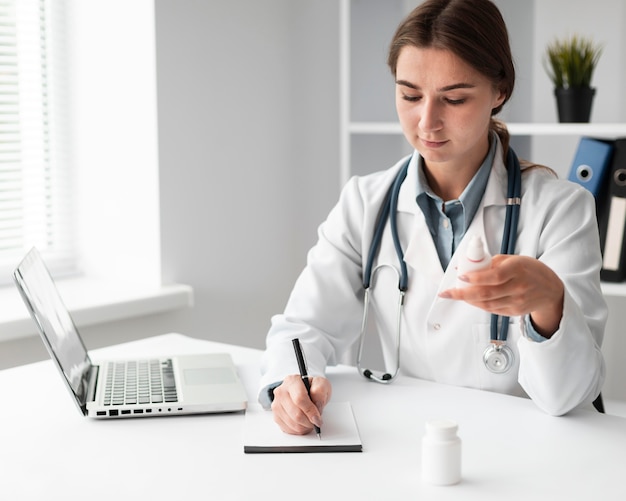 Free photo doctor writing medical prescription