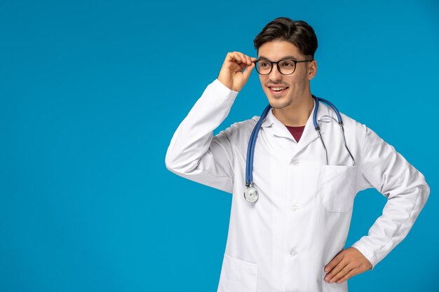 Doctors day handsome brunette cute guy in medical gown smiling with stethoscope