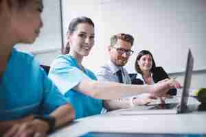 Free photo doctors discussing over laptop in meeting