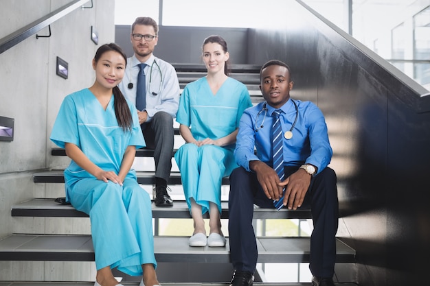 Doctors and nurses sitting on staircase