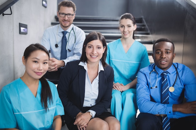 Doctors and nurses sitting on staircase