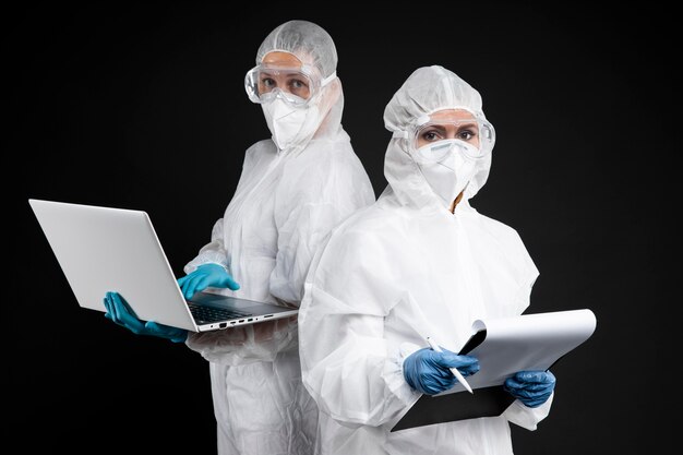 Doctors posing while wearing protective wear