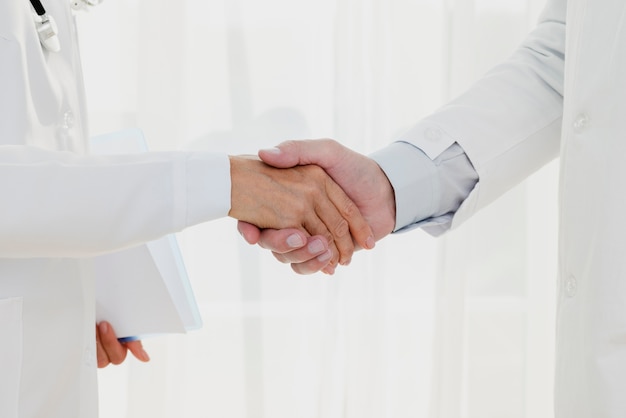 Doctors shaking hands close-up