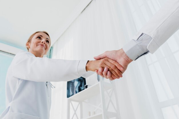 Doctors shaking hands low angle