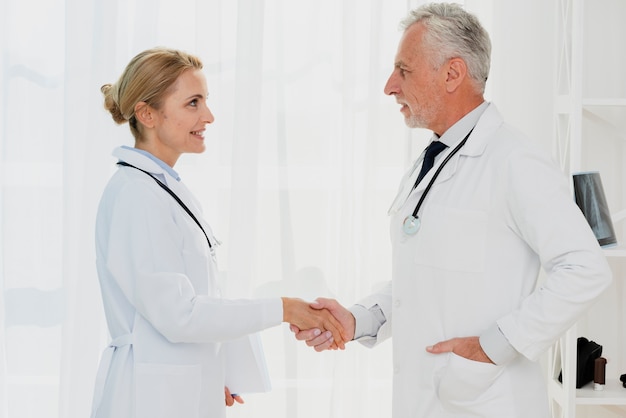 Doctors shaking hands side view