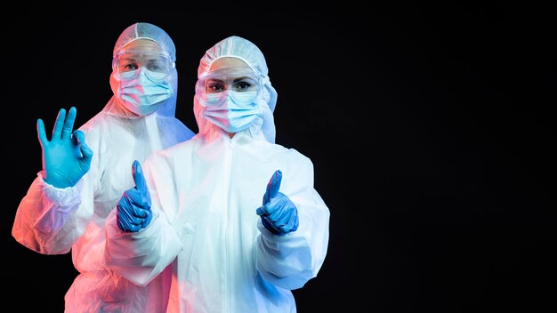 Doctors wearing protective medical equipment with copy space