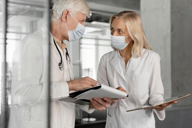 Doctors with medical masks talking