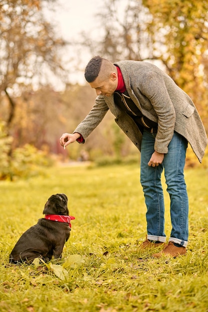 Dog training. A man training his dog in the park