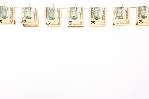 Free photo dollar banknotes hanging on clothesline