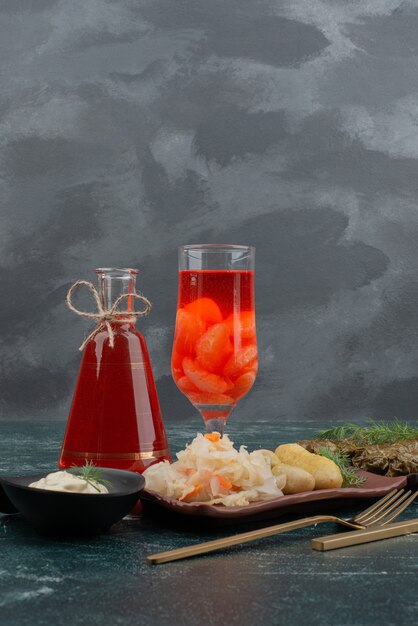 Dolma with glass and bottle of juice on marble wall