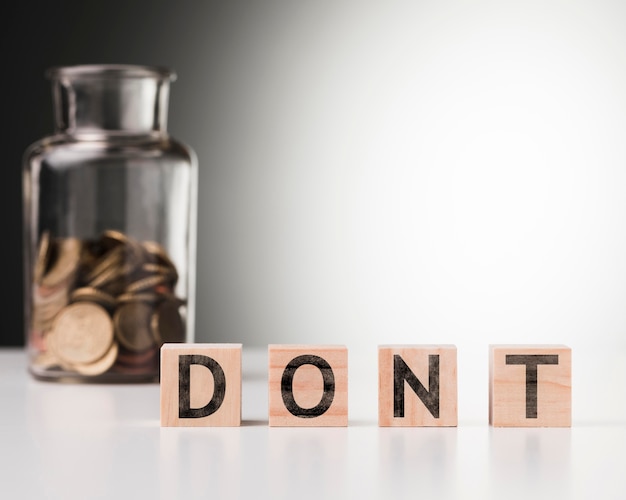 Free photo dont word beside jar with coins