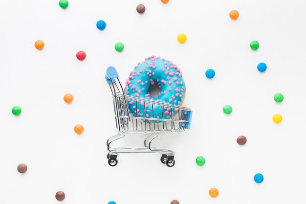 Donut in shopping cart flat lay