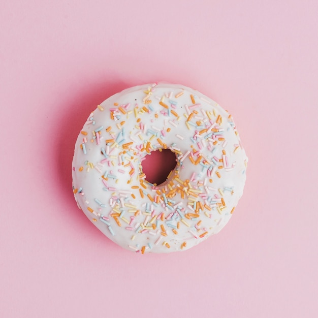Donut with topping sprinkle on pink background