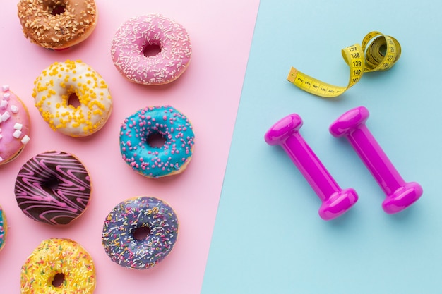 Free photo donuts and gym equipment top view