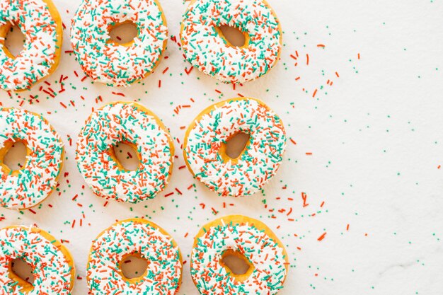 Donuts with white chocolate cream and sprinkles sugar
