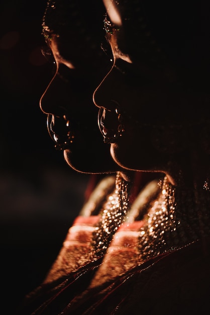 Double exposure. Silhouette of charming Hindu bride in tradition