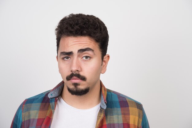 Doubtful close up portrait of young man.