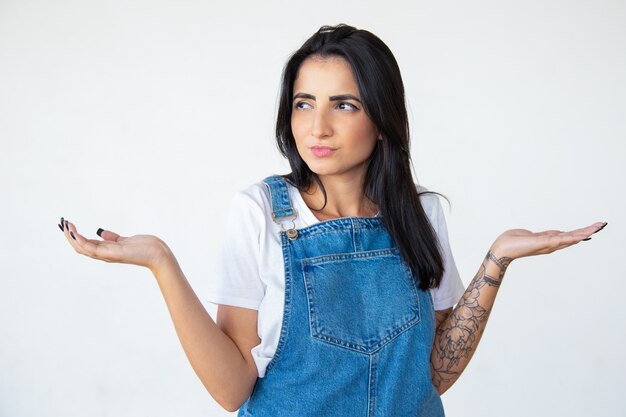 Doubting woman with raised hands