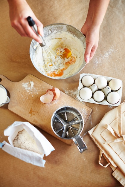 Dough is being prepared in the bowl