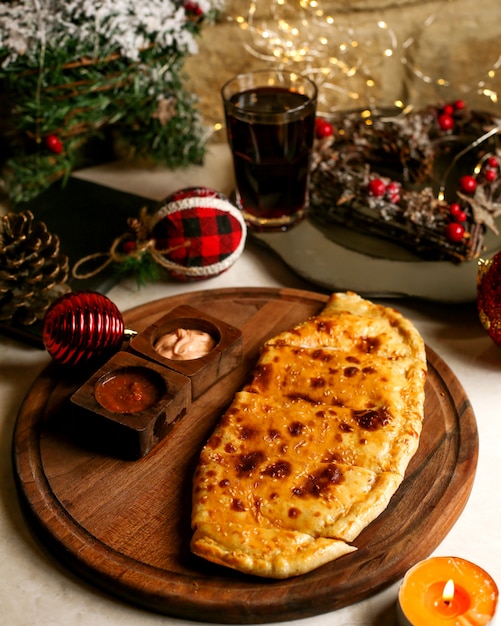 Dough pastry encrusted with sesame served with sauces