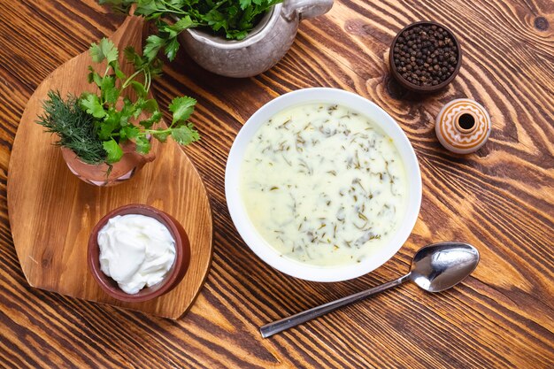 Dovga traditional soup with greens and plain yoghurt top view