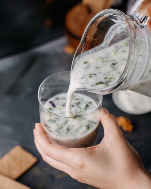 dovga yogurt boiled pouring inside glass on grey