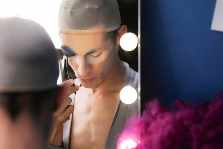 Free Photo drag person putting on makeup