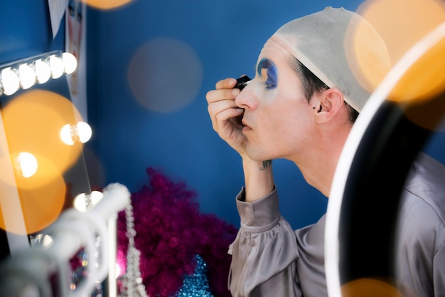 Drag person putting on makeup