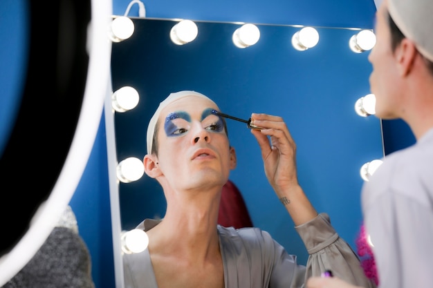 Drag person putting on makeup