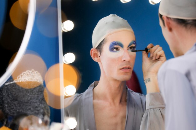 Drag person putting on makeup