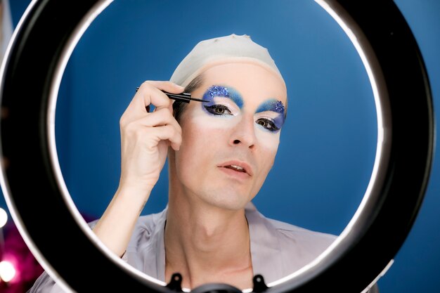 Drag person putting on makeup