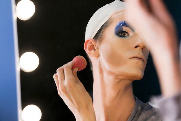 Drag person putting on makeup