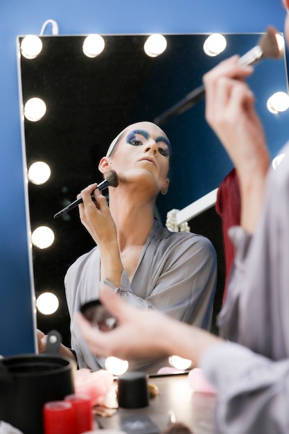 Drag person putting on makeup