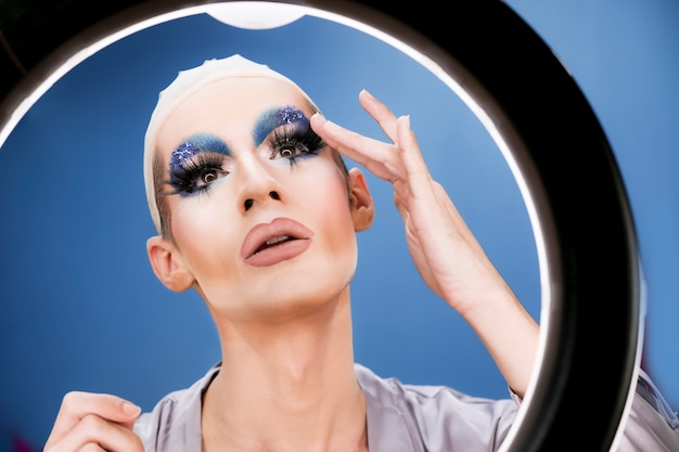 Drag person putting on makeup