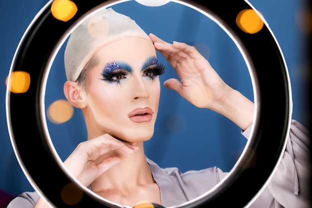 Drag person putting on makeup