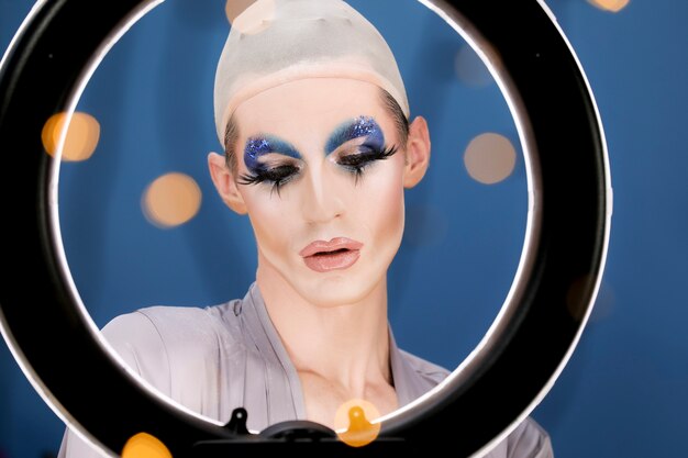 Drag person putting on makeup