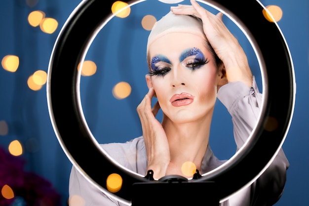 Drag person putting on makeup