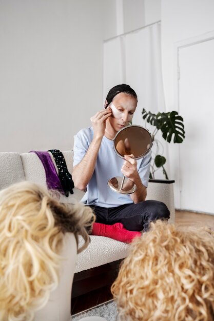 Drag queen putting makeup on full shot