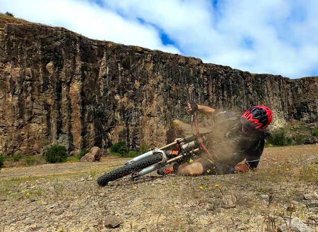 Dramatic shot of a cyclist falling down after a dangerous trick