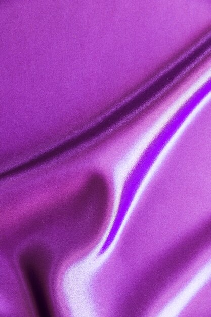 滑らかな紫色のサテンの背景のドレープ