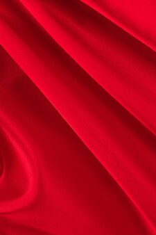 サテン​織り​テクスチャ​背景​の​ドレープ​赤い​シルク​生地