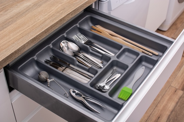 Drawer with cutlery in kitchen