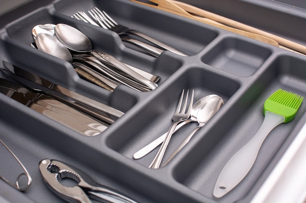 Drawer with cutlery in kitchen