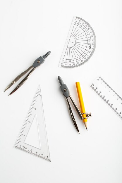 Drawing figures as triangle and compass a top view on white wall