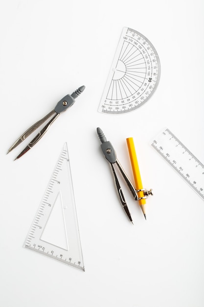 Drawing figures as triangle and compass a top view on white wall