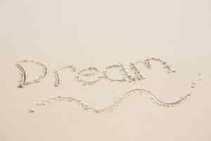 Free photo dream written on sand